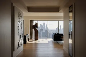A modern residential apartment featuring concrete walls and glass windows.