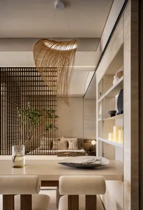 Minimalist dining room featuring concrete and wooden elements, with a modern chandelier and decorative elements.
