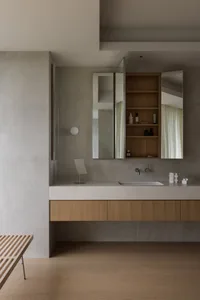 Modern bathroom with concrete walls and wooden vanity