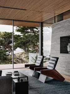 Modern living room featuring wood, glass, stone, and leather materials.