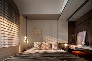 A modern minimalist bedroom featuring wooden furniture, soft lighting, and a stylish color palette.