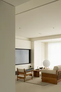 A minimalistic living room with a wooden sofa and table.