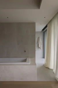 Modern minimalist bathroom featuring marble finishes and a serene atmosphere.