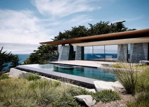 A modern pool house featuring metal and glass construction.