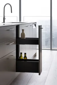 A modern kitchen with a metallic pull-out cabinet storage system.