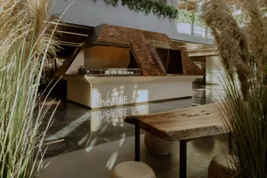 A modern bar with wooden elements and greenery