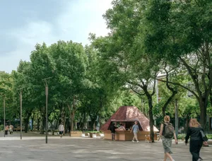 People walking in a park with trees providing shade.