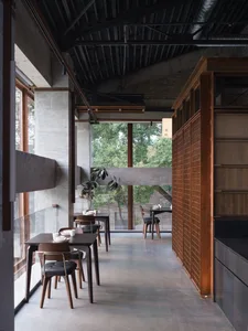 Modern restaurant with concrete walls and wooden tables and chairs
