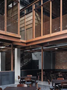 Modern, industrial-themed restaurant interior featuring wood and concrete materials.