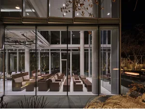 Modern glass and concrete waiting area with seating