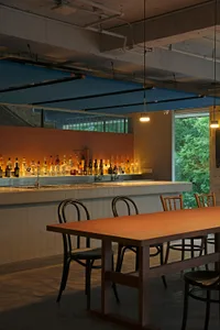 Industrial-style bar with concrete, tile, and exposed pipes