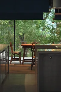 A modern coffee shop interior with wooden furniture and a view of greenery through large windows.