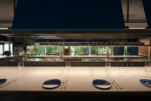 A contemporary restaurant kitchen featuring white and blue ceramic tiles.