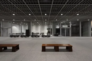 A spacious, modern office interior featuring exposed concrete and steel structural elements.