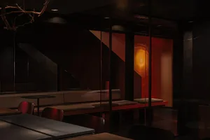 Modern restaurant interior with dark lighting and glass walls, showcasing sophisticated design elements.