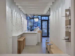 Minimalist coffee shop interior with concrete seating and modern decor