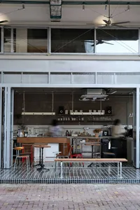 Modern interior of a coffee shop featuring metal, wood, and glass elements.