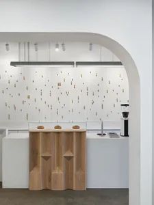 Modern minimalist coffee shop with wood and concrete elements.