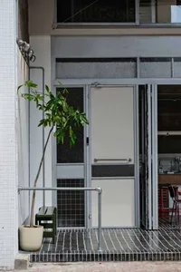 A modern commercial interior featuring metal elements, including a door with glass panels and metallic fixtures.
