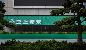 A storefront with a green awning and white text.