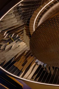 Modern industrial interior with metallic elements and reflective surfaces.