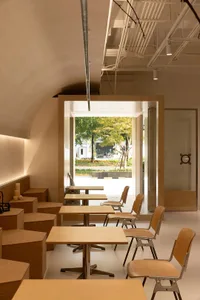 Minimalist cafe interior with wooden tables and chairs