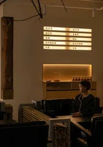 A modern coffee shop with wooden furniture and glass decorations.