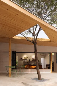 A modern coffee shop with wooden interior features and a large window allowing natural light to flood the space.