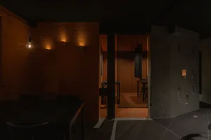 A minimalist indoor space with concrete walls and floor.
