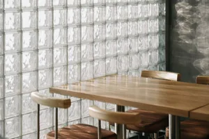 A modern cafe interior featuring a wooden table and chairs.