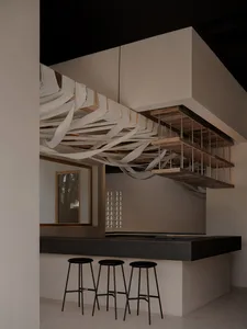 Modern interior design featuring a concrete bar counter with three stools.