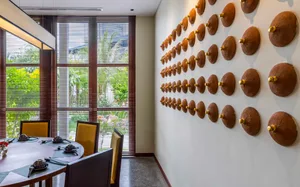 Modern dining room featuring wooden furniture and decorative wall art.
