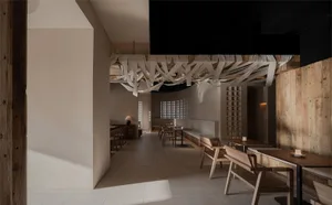 Interior design of a minimalist restaurant featuring wooden materials.