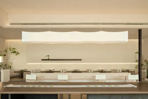 A minimalist modern restaurant interior designed with contemporary furniture and clean lines.