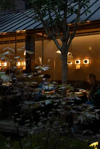 People dining in a restaurant with glass window frames