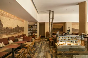 A cozy cafe interior with wooden elements and a rustic design.