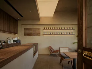 A minimalist coffee shop with a wooden counter, chairs, and a menu board.