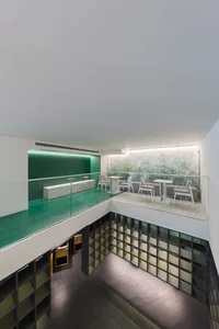 Modern cafe interior with concrete, glass, and metal materials