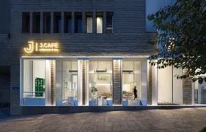 A modern cafe interior with glass and brick materials