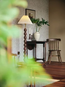 A modern living room featuring a marble coffee table and wooden furniture.