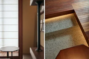 A modern indoor staircase with wooden steps and a carpet runner.