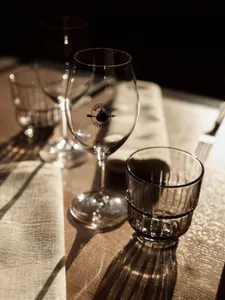 Empty wine glasses and a drink glass on a table.