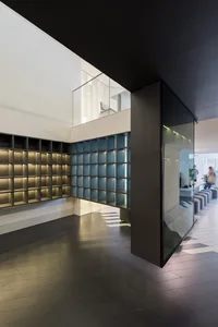 A minimalist interior space featuring glass shelves with warm ambient lighting.