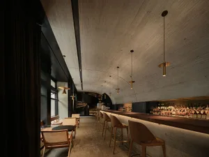 Industrial-style bar with concrete walls and hanging lights