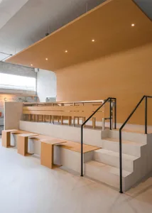 A minimalist interior design featuring concrete and wood materials.