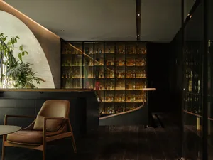 Industrial-style bar counter featuring wood, glass, and metal materials