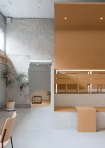 A modern coffee shop interior with wood and concrete materials.