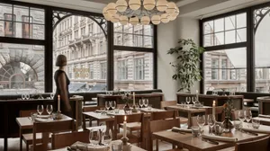 A modern restaurant interior with wooden tables, glass chandeliers, and lit candles.