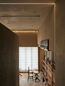 Modern cafe interior featuring wooden shelves and tables