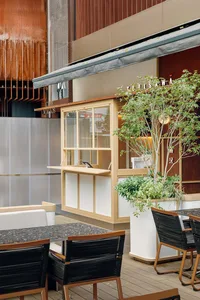 Outdoor seating and modern glass facade of a cafe